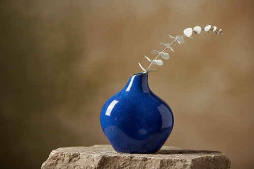 Blue ceramic vase on natural stone